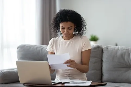 woman looking over financial paperwork